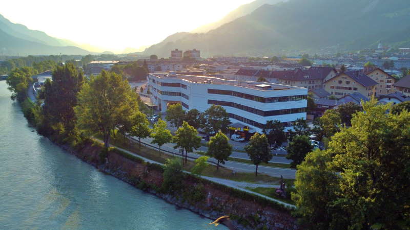 Morgendämmerung über dem Geschäftssitz der SEO Agentur Tirol am Flussufer mit Blick auf die Alpen